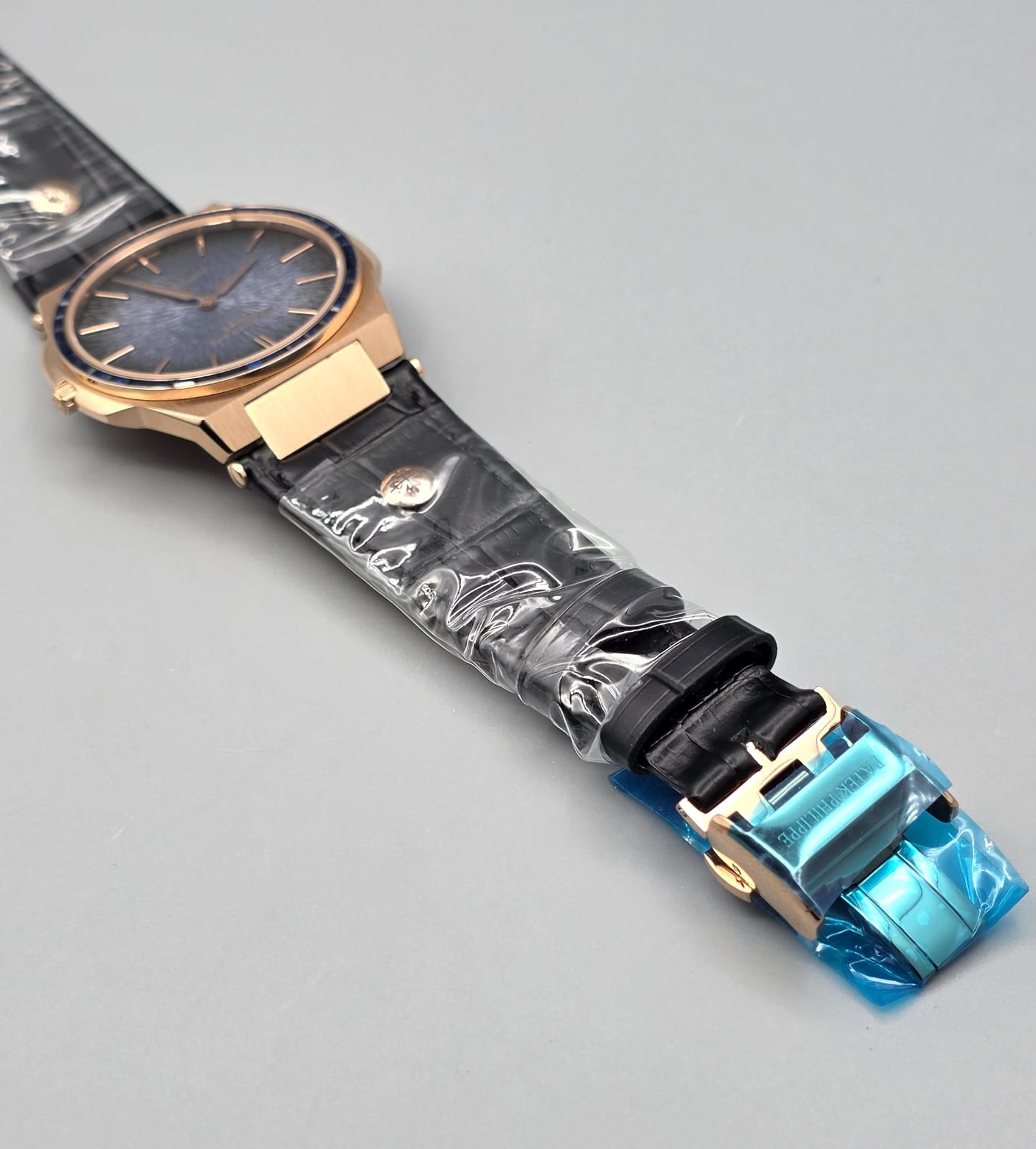 Gold-Tone Luxury Watch with Blue Stone-Set Bezel Textured Dial