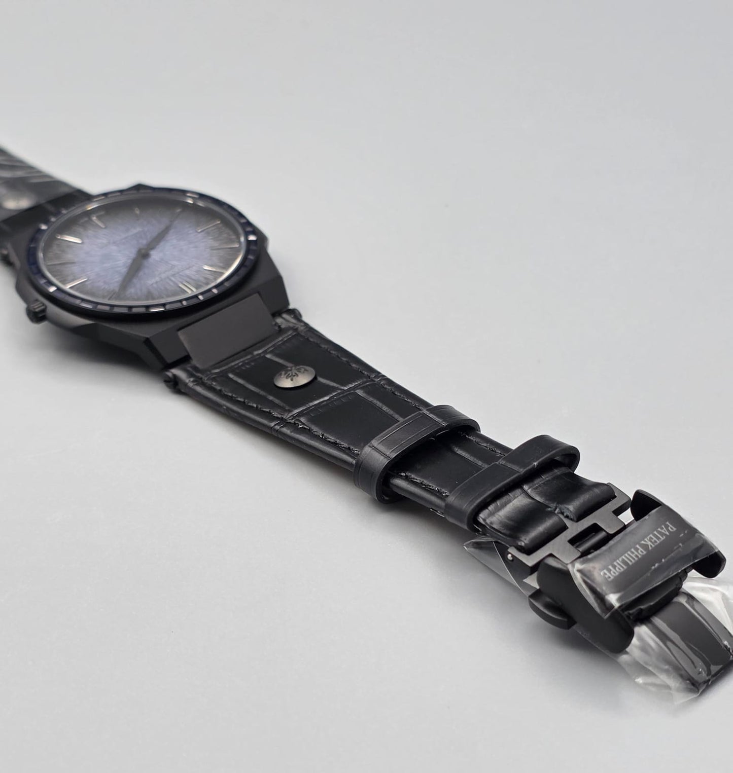 Black Luxury Watch with Blue Stone-Set Bezel & Textured Dial