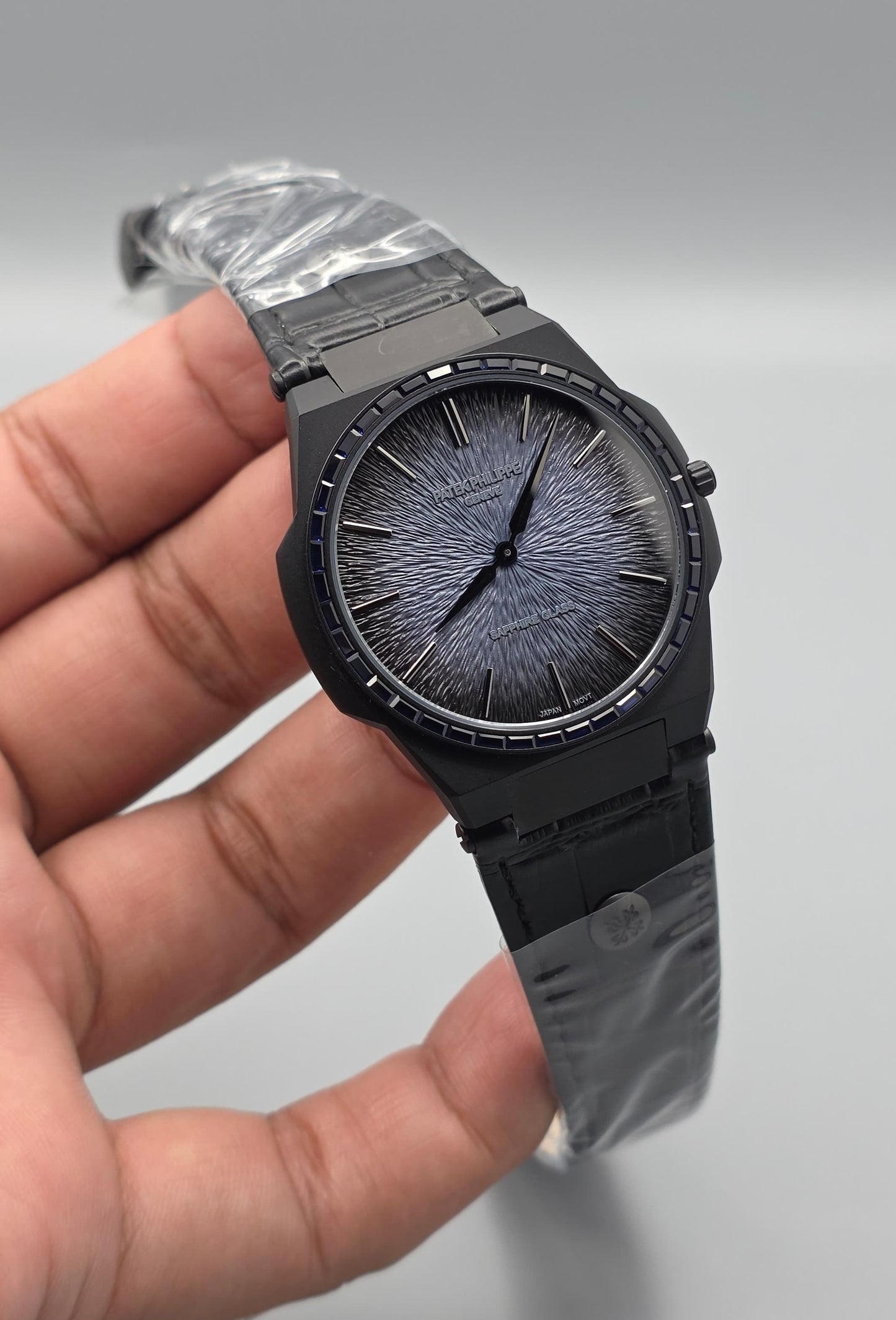 Black Luxury Watch with Blue Stone-Set Bezel & Textured Dial